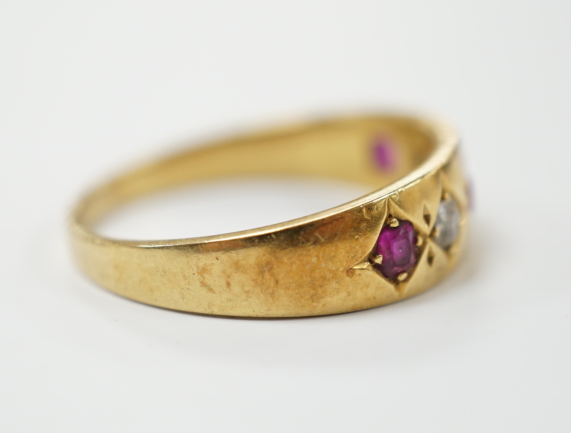 An early 20th century yellow metal ruby and diamond set five stone dress ring, size P